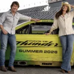 Tom Cruise and Anne Hathaway with the Days of Thunder race car at Daytona International Speedway