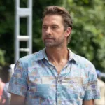 Scott Speedman as R.J. Decker stands outdoors in a blue patterned shirt in Season 2 Episode 4, “The Angler.”