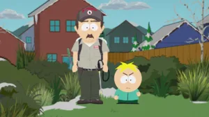 Butters holds a sheet of paper in front of his classmates while Mr. Garrison watches in South Park Season 29 Episode 2, “Billionaire Weenietown.”