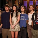 SATURDAY NIGHT LIVE -- Episode 1906 -- Pictured: Host Dakota Johnson (center) with musical guest Turnstile during Promos on Thursday, October 1, 2026 -- (Photo by: Rosalind OConnor/NBC)