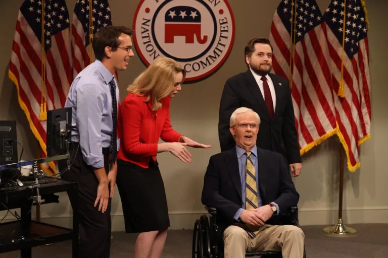 SATURDAY NIGHT LIVE -- Episode 1906 -- Pictured: (l-r) Andrew Dismukes and Ashley Padilla as political aid, Mikey Day as Mitch McConnell, and Jeremy Culhane as JD Vance during the "Midterm Ads Cold Open" on Saturday, October 3, 2026 -- (Photo by: Will Heath/NBC)