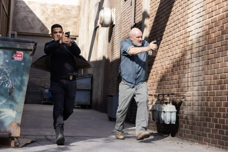 NCIS Season 24 Episode 3 "Sleeping Dogs" -- Coverage of the CBS Original Series NCIS, scheduled to air on the CBS Television Network. Pictured (L to R): Wilmer Valderrama as Nicholas “Nick” Torres, Mike O’Malley as Walt Keller Photo: Sonja Flemming/CBS ©2026 CBS Broadcasting, Inc. All Rights Reserved.